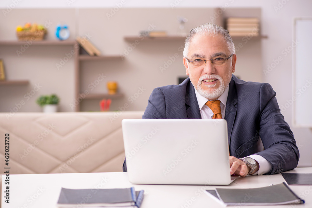 Old male employee working from home during pandemic Old male employee working from home during pandemic