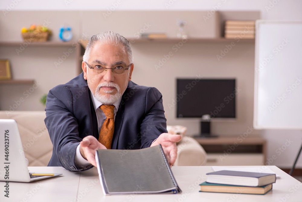 Old male employee working from home during pandemic Old male employee working from home during pandemic