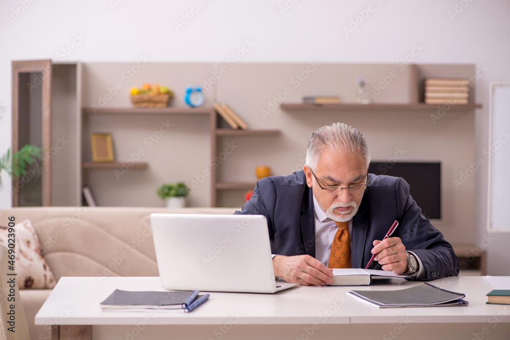 Old male employee working from home during pandemic Old male employee working from home during pandemic