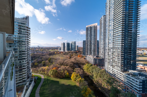 High-angle winter view of condominium buildings, houses, and the lakeshore district in South Etobicoke, Toronto, Ontario with snow-dusted rooftops in bright daylight
