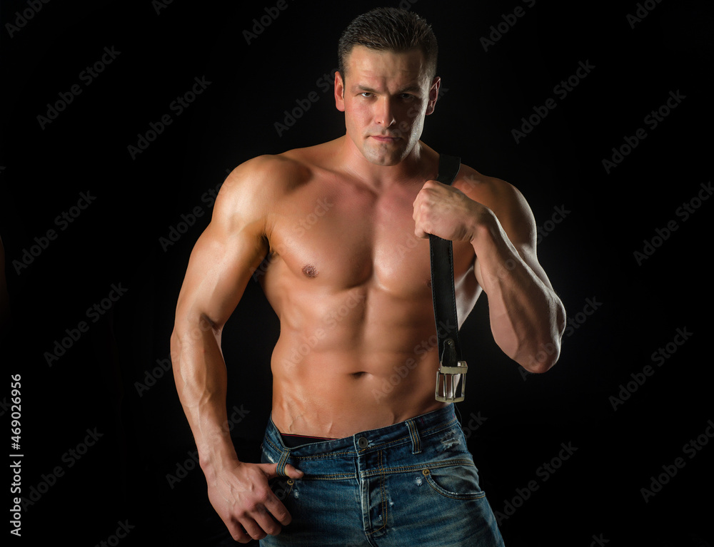 Male hunk with athletic body on black. Metrosexual concept. Fashion style portrait of handsome guy.