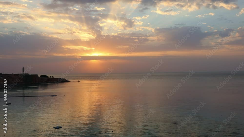 Panoramic view of beach Ras Umm El Sid. Beautiful sunrise over Red Sea with rocky shores, sandy beach with umbrellas and first rays of sun, Sharm El Sheikh, Egypt. Vacation concept. 4k footage Panoramic view of beach Ras Umm El Sid. Beautiful sunrise over Red Sea with rocky shores, sandy beach with umbrellas and first rays of sun, Sharm El Sheikh, Egypt. Vacation concept. 4k footage