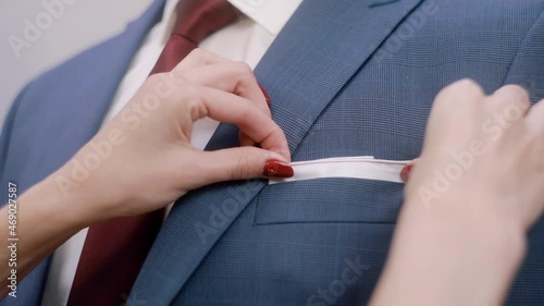 Businessman with red tie. Female hands put a handkerchief in his pocket. Male accessory, elegant style. Prepare for the event. photo