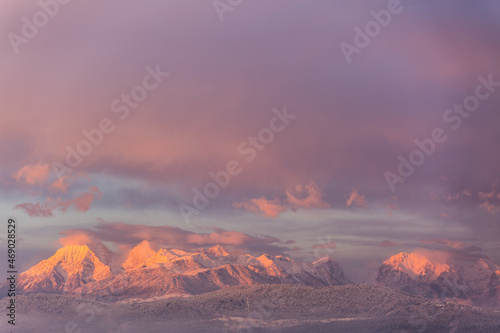 Amazing sunset winter of snow caped Kamnisko-Savinjske Alpe mountains, Slovenia, Europe photo