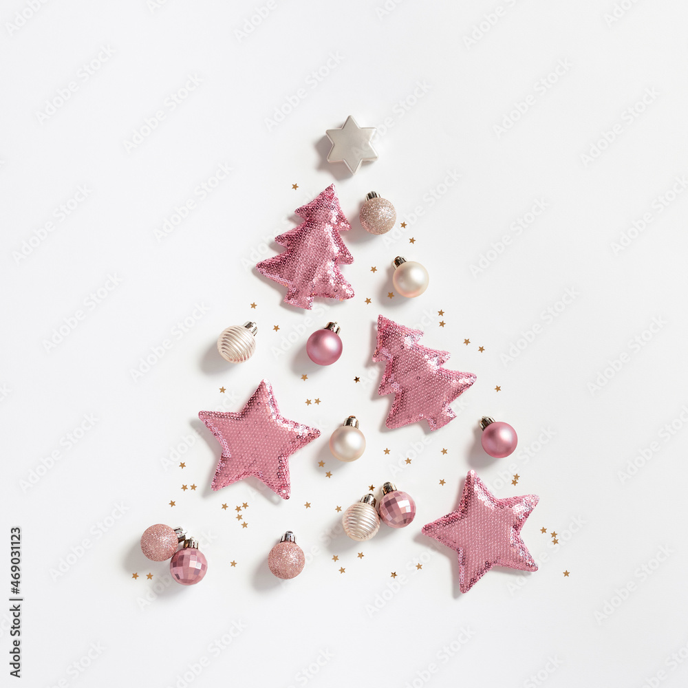 Christmas tree from christmas glitter toys, minimal New Year composition pink color, monochrome image. New Year holiday layout Christmas tree from christmas glitter toys, minimal New Year composition pink color, monochrome image. New Year holiday layout