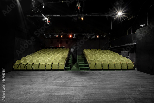 small auditorium with green armchairs
