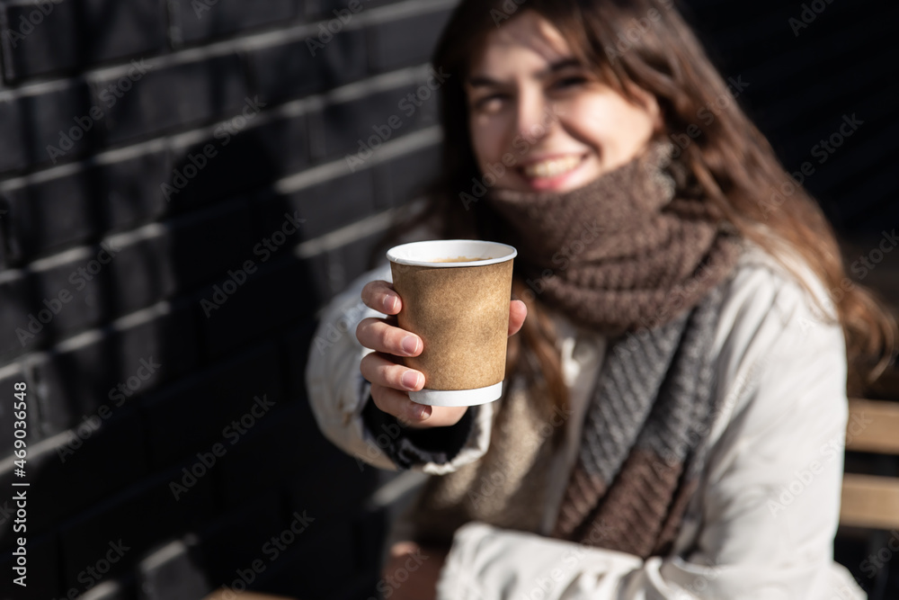 Close-up of a paper cup of hot drink in female hands. Close-up of a paper cup of hot drink in female hands.