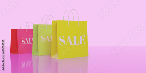 3d render. Yellow, green and pink paper shopping bags with the inscription Sale on a pink background. On the right is a place for an inscription.
