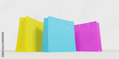 3d render. Yellow, blue and pink paper shopping bags on a white background. Bottom view, close-up.
