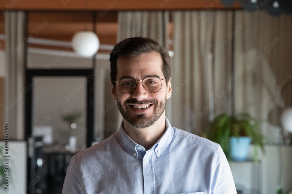 Head shot smiling confident young ceo executive male manager employee worker businessman in eyewear posing in modern office room, professional profile photo, video call virtual meeting concept. Head shot smiling confident young ceo executive male manager employee worker businessman in eyewear posing in modern office room, professional profile photo, video call virtual meeting concept.