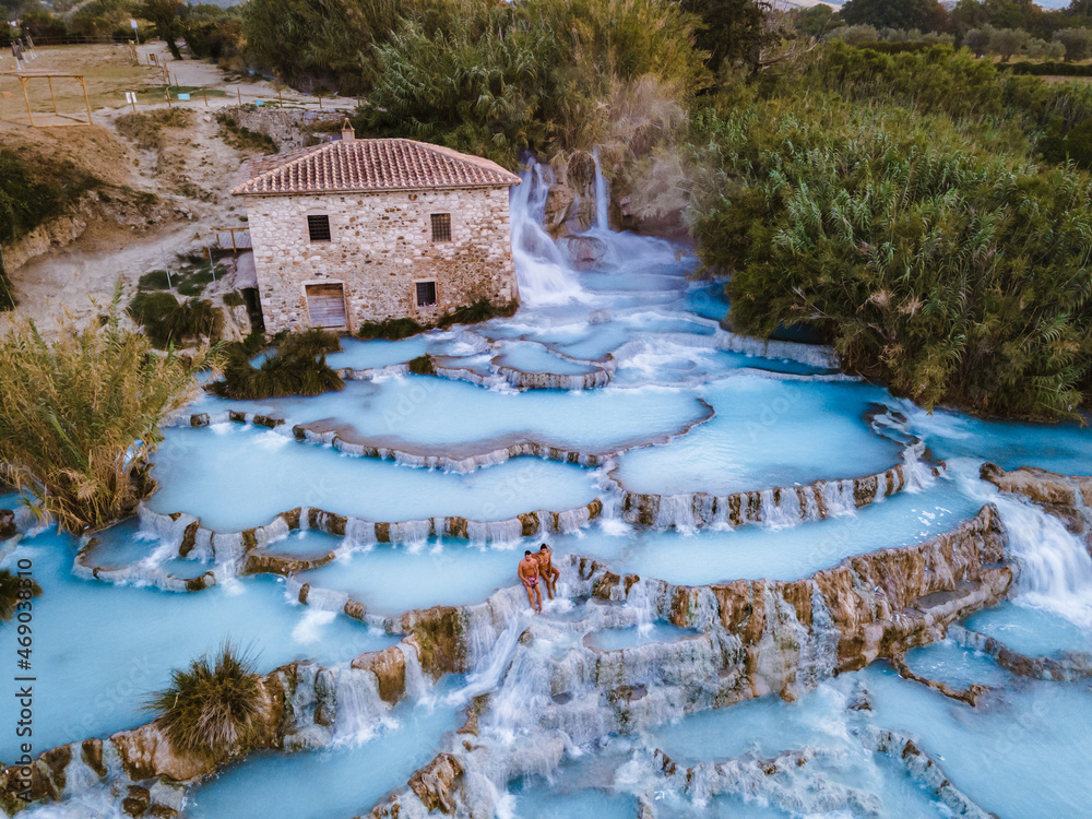 Toscane Italy, natural spa with waterfalls and hot springs at Saturnia thermal baths, Grosseto, Tuscany, Italy aerial view on the Natural thermal waterfalls couple at vacation at Saturnia Toscany - obrazy, fototapety, plakaty 