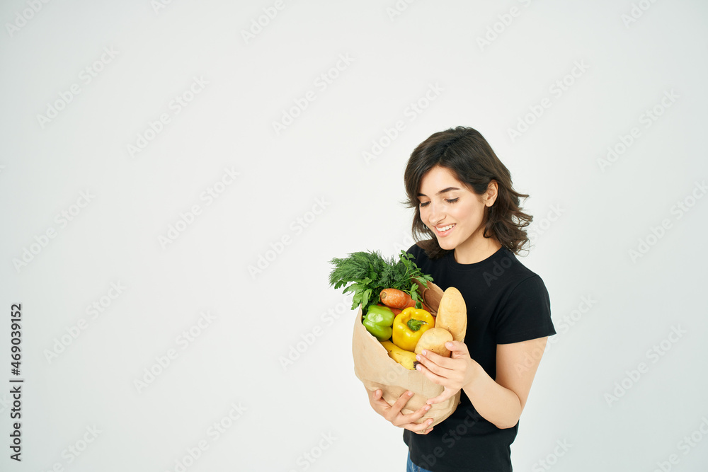cheerful woman with a package of groceries vegetables delivery cheerful woman with a package of groceries vegetables delivery