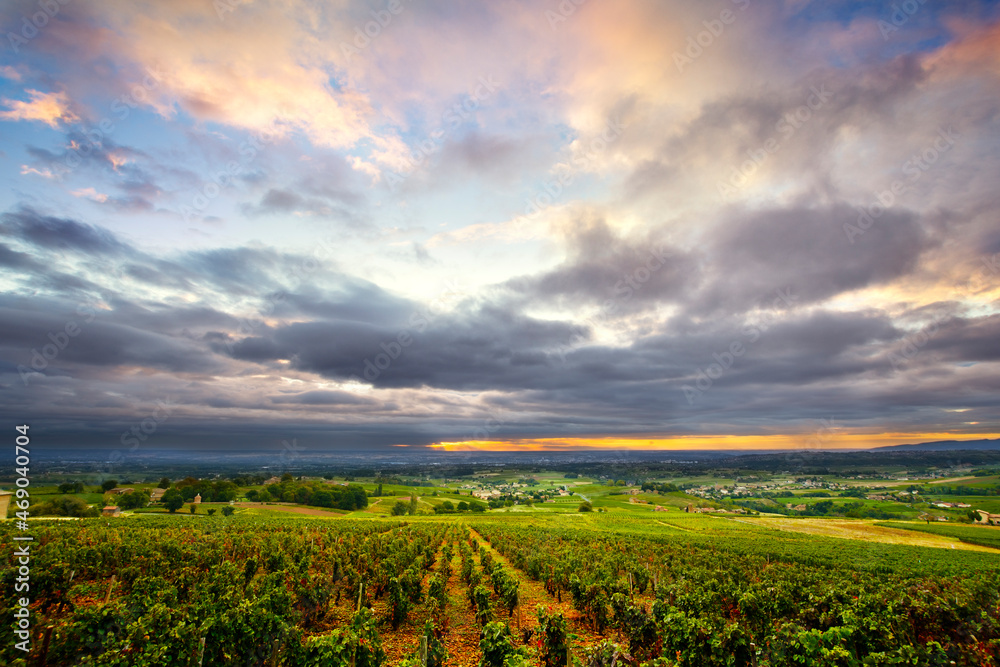 Clouds at sunrise time over vineyards of Beaujolais, France
