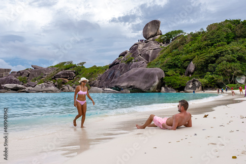 Similan Islands Phuket, tropical white beach with palm trees and blue ocean in Thailand Andaman sea, couple man and woman mid age on vacation in Thailand