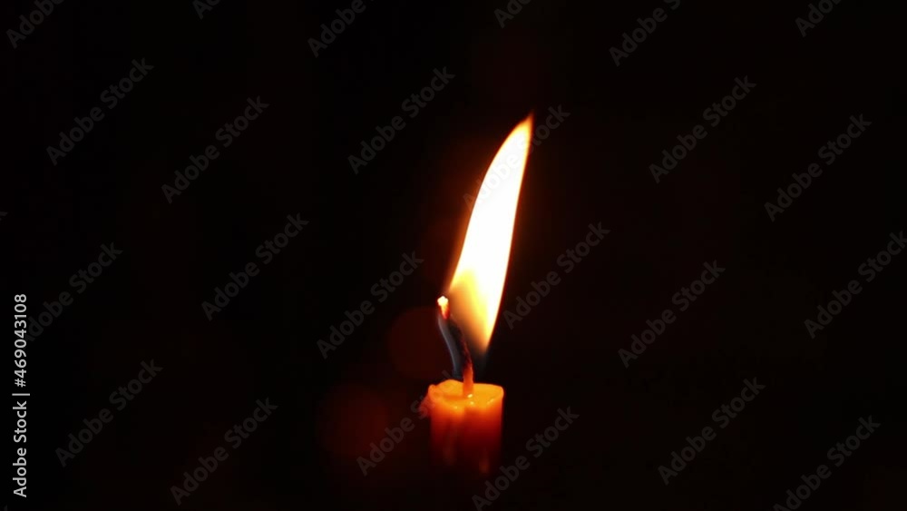 Close up flame moving on yellow candles in the dark Close up flame moving on yellow candles in the dark