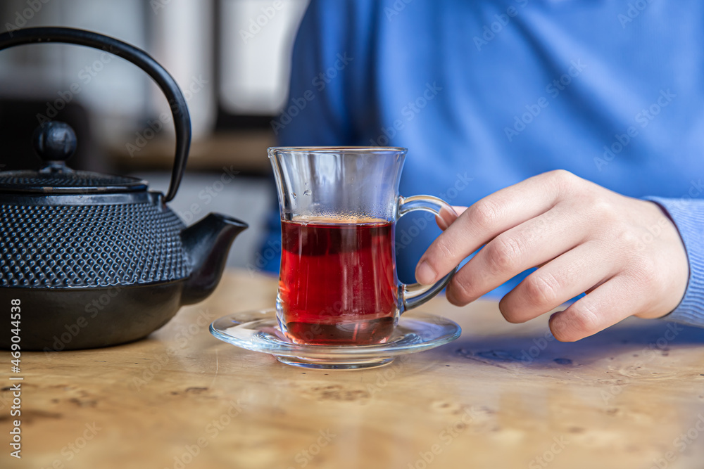 Close up of tea and black textured cast iron teapot. Close up of tea and black textured cast iron teapot.