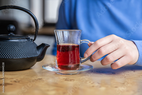 Close up of tea and black textured cast iron teapot.