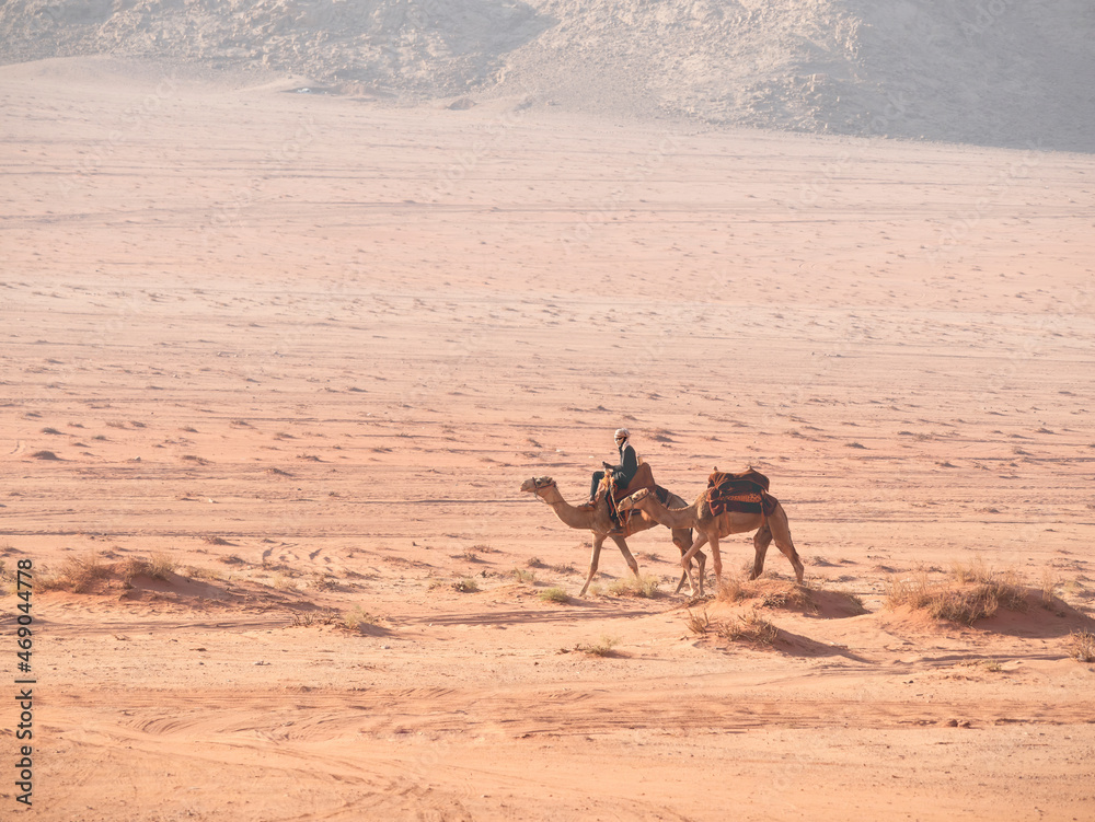 Arab bedouin man riding a camel in the desert of Wadi Rum, Jordan. Arab bedouin man riding a camel in the desert of Wadi Rum, Jordan.