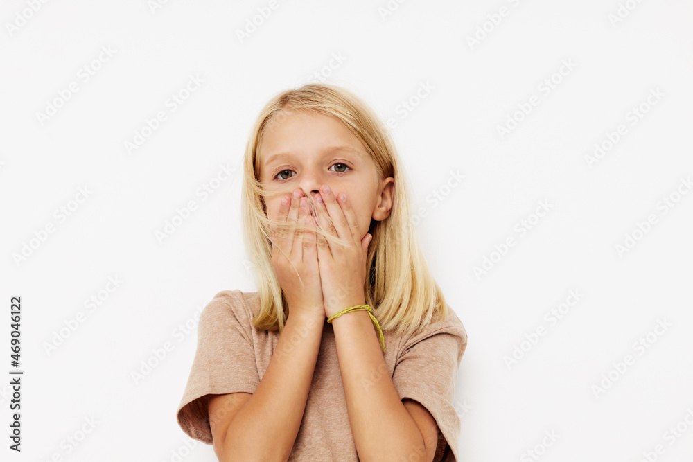 Positive little girl gestures with his hands isolated background Positive little girl gestures with his hands isolated background