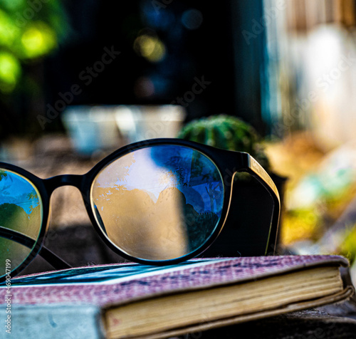 glasses and the diary (wrote the word Tee Lau Zu on it) put on the wooden bench in relaxing time.