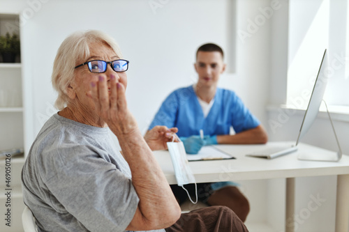 an elderly woman is examined by a doctor professional consultation