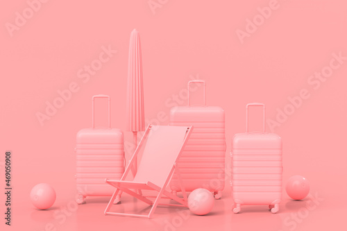 Suitcase with beach ball, umbrella and chair on monochrome pink background photo