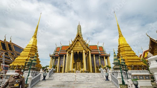 4K Timelapse of Wat Phra Si Rattana Satsadaram (Wat Phra Kaew) or Temple of the Emerald buddha over blue sky and white cloud. Most popular temple of tourist in Bangkok, Thailand photo