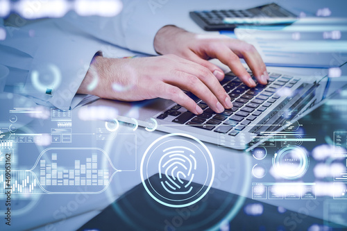 Businessman is typing message on laptop. Digital interface with hud