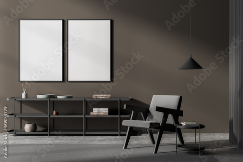 Dark art room interior with armchair and coffee table, mockup posters