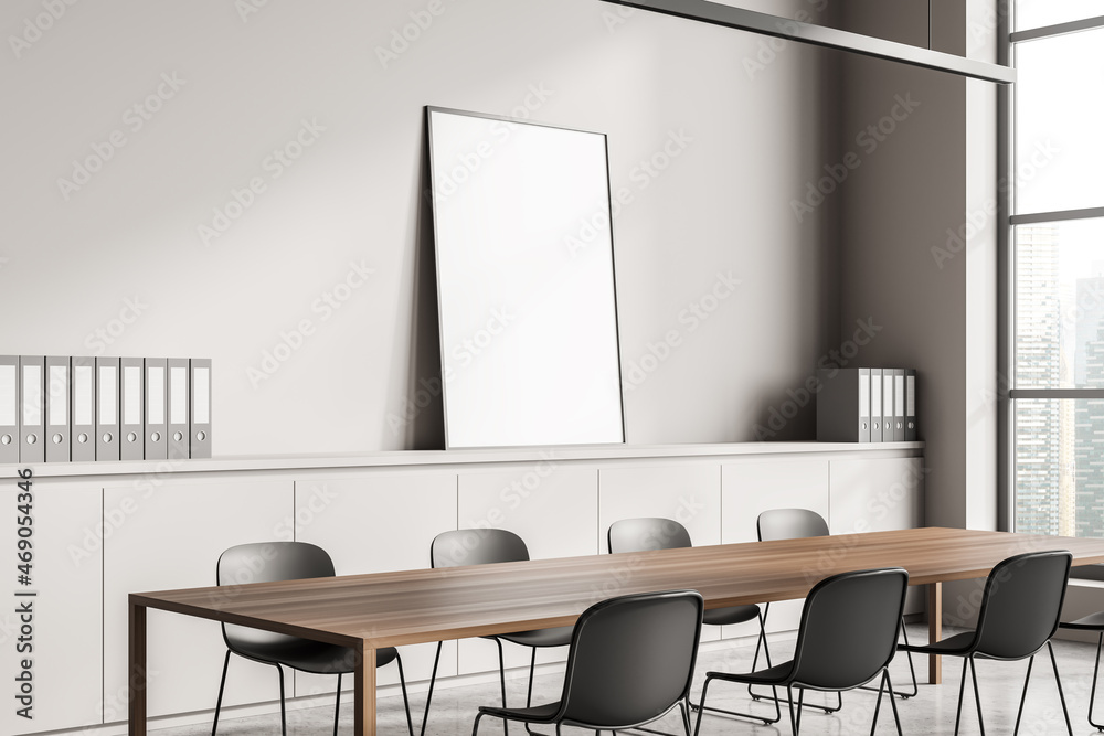 Fototapeta premium Minimalist conference interior behind near windows, drawer and mockup poster