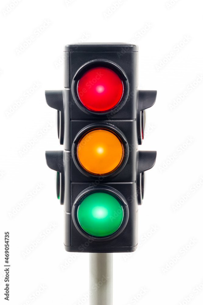 Vertical view of a traffic light showing illuminated red, amber, and green lights.  Concept image illustrating control of the COVID pandemic and confusion.

 - obrazy, fototapety, plakaty 