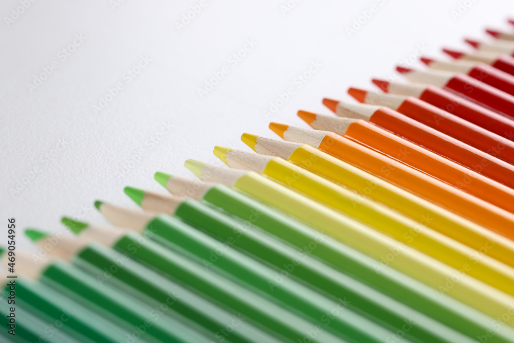 Colored pencils with sharp tips lie in a row, close-up Colored pencils with sharp tips lie in a row, close-up
