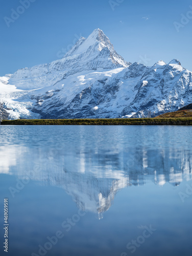High mountains and reflection on the surface of the lake. Mountain valley wit...