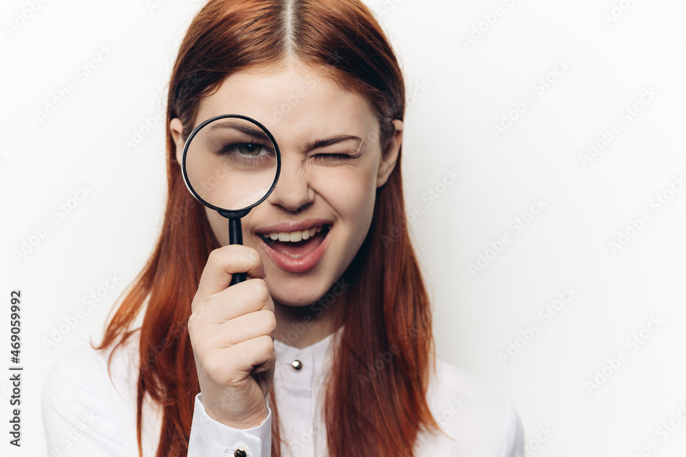 pretty woman grimacing with magnifying glass near face pretty woman grimacing with magnifying glass near face