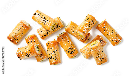 Turkish borek rolls with spinach and cheese. A traditional Turkish pastry rulo borek with black and white sesame seeds. Isolated on white background. top view photo