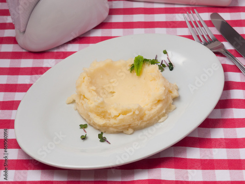 mashed potatoes on a white plate in a restaurant