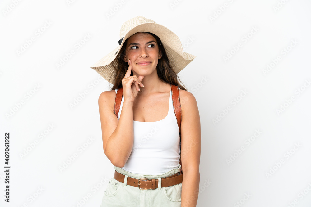 Young caucasian woman wearing a Pamela in summer holidays isolated on white background thinking an idea while looking up Young caucasian woman wearing a Pamela in summer holidays isolated on white background thinking an idea while looking up