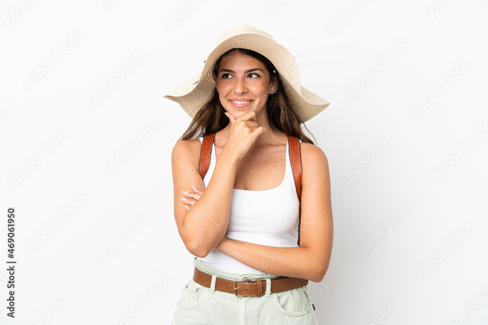 Young caucasian woman wearing a Pamela in summer holidays isolated on white background looking to the side Young caucasian woman wearing a Pamela in summer holidays isolated on white background looking to the side