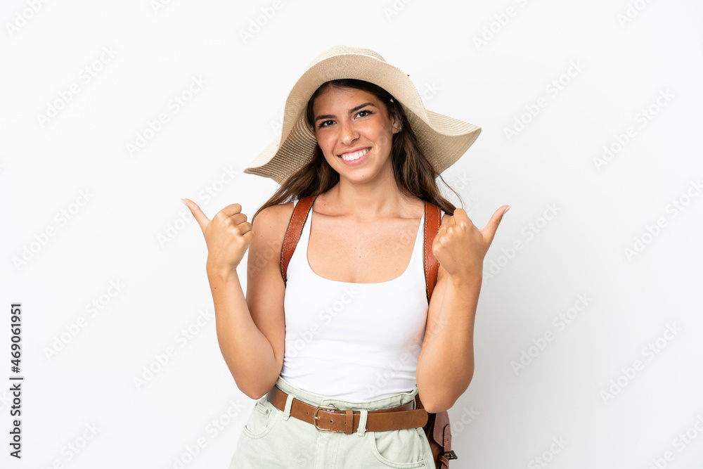 Young caucasian woman wearing a Pamela in summer holidays isolated on white background with thumbs up gesture and smiling Young caucasian woman wearing a Pamela in summer holidays isolated on white background with thumbs up gesture and smiling