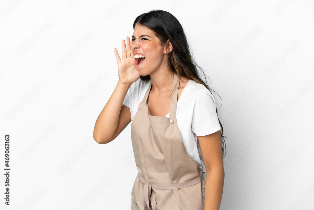 Restaurant waiter over isolated white background shouting with mouth wide open to the lateral Restaurant waiter over isolated white background shouting with mouth wide open to the lateral