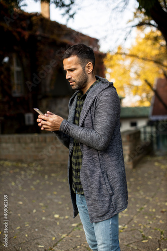 Young man using mobile phon...