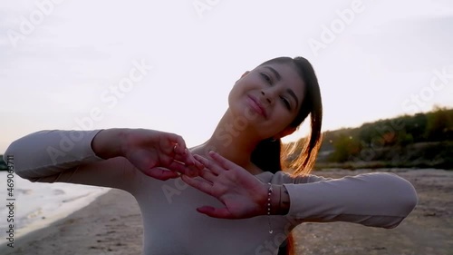 rejoicing and smiling young girl on the beach, sunset time.