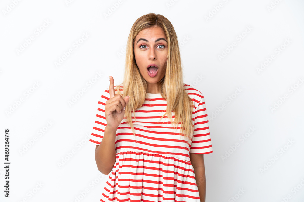 Blonde Uruguayan girl isolated on white background intending to realizes the solution while lifting a finger up Blonde Uruguayan girl isolated on white background intending to realizes the solution while lifting a finger up
