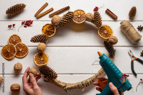 Natural components wreath. Woman's hands making natural eco Christmas decoration.