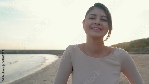 rejoicing and smiling young girl on the beach, sunset time.