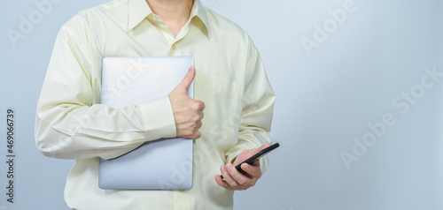 man hold laptop and mobile with right white copy space background