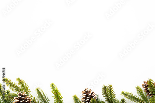 White table with Christmas decoration including pine branches and pine cones. Merry Christmas and happy new year concept. Top view with copy space, flat lay.