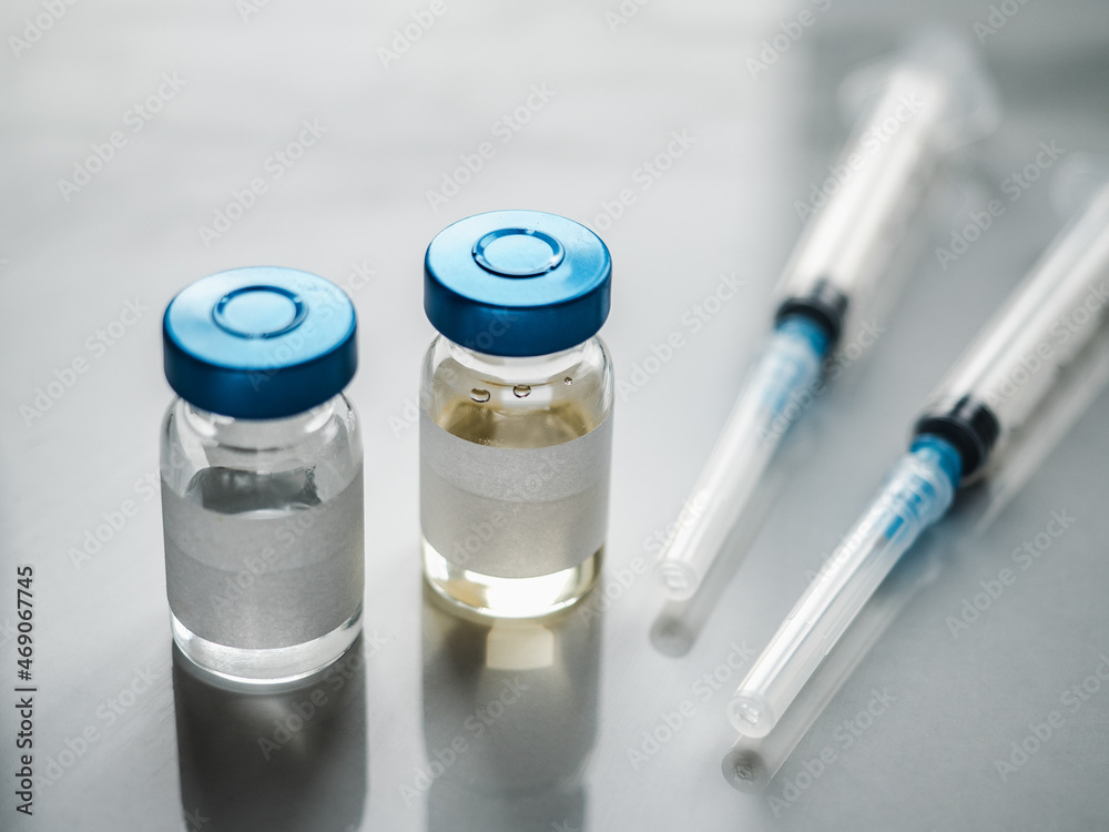 Syringes, injection bottles and tablets lying on the table. Close-up, indoors, view from above. Day light, studio photo. Healthcare concept Syringes, injection bottles and tablets lying on the table. Close-up, indoors, view from above. Day light, studio photo. Healthcare concept
