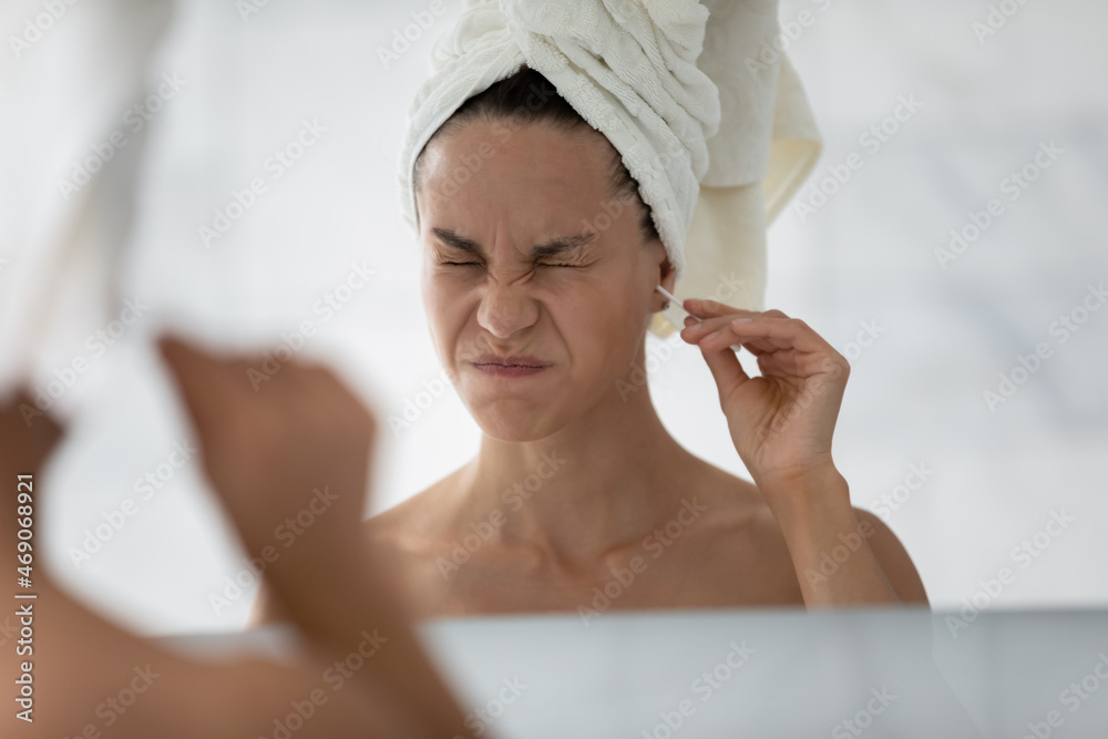 Head shot stressed young hispanic latina woman feeling pain using