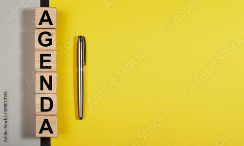 Agenda word on yellow background with copy space for text. photo